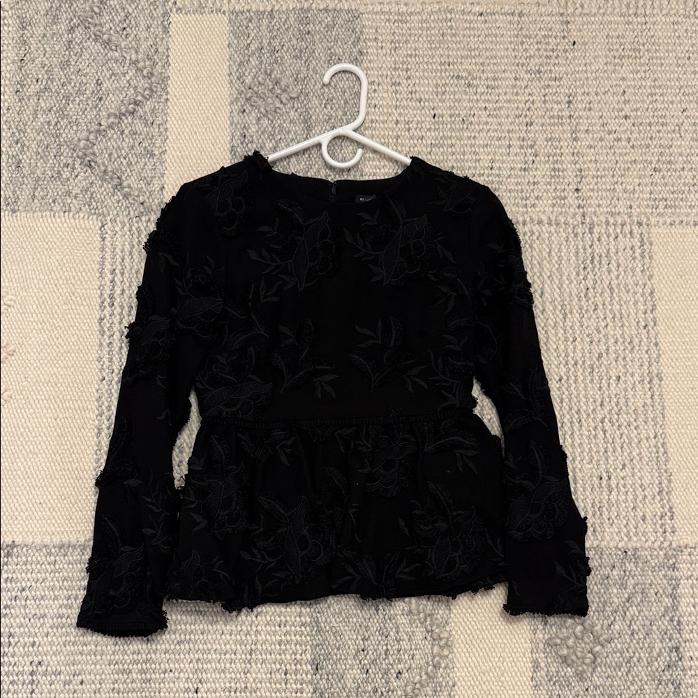 Peplum top with floral aplique